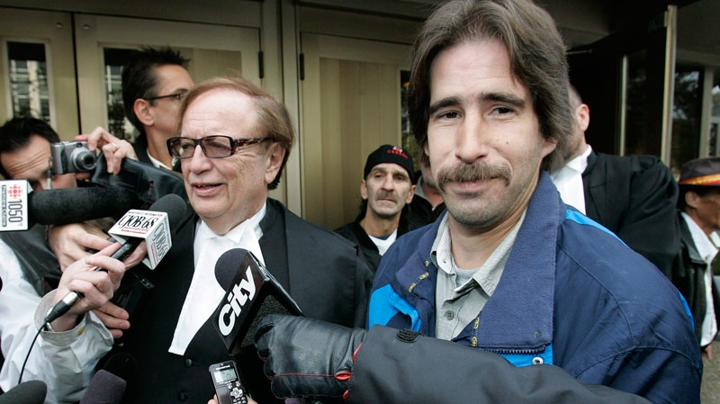 Kyle Unger, right, and his lawyer, Hersh Wolch, talk to media outside a Winnipeg courthouse on Friday, October 23, 2009. (John Woods / THE CANADIAN PRESS)