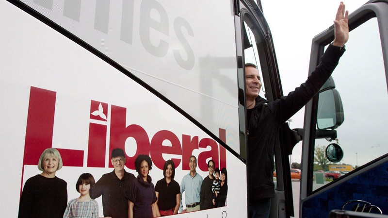 Liberal Leader Dalton McGuinty waves as he boards his campaign bus after a stop in Belleveille, Ont. on Sept. 21, 2011. (Lars Hagberg / THE CANADIAN PRESS)