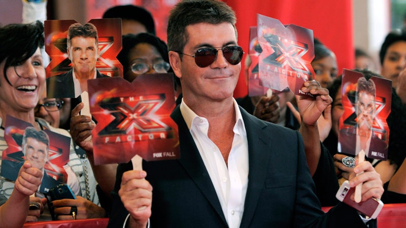 Simon Cowell, executive producer and a judge on 'The X Factor,' poses for photographers at a world premiere screening event for the new television series, Wednesday, Sept. 14, 2011. (AP / Chris Pizzello)