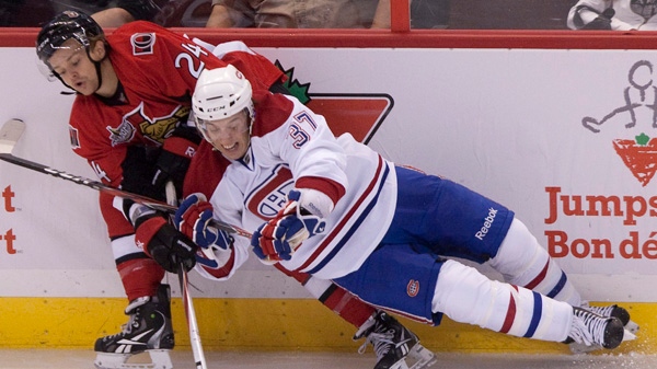 Ottawa Senators' Stephane Da Costa collides with Montreal Canadiens' Garbiel Dumont along the boards during second period pre-season NHL action in Ottawa, Friday September 23, 2011. THE CANADIAN PRESS/Adrian Wyld