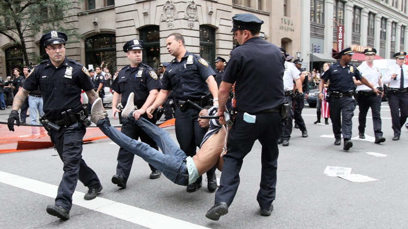 Police carry away a participant in a march organized by Occupy Wall Street in New York on Saturday Sept. 24, 2011. (AP Photo/Tina Fineberg)