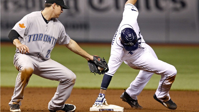 Tampa Bay Rays' Johnny Damon, right, reaches back to stay on-base after stealing second past the attempted tag by Toronto Blue Jays second baseman Kelly Johnson during the sixth inning of a baseball game on Saturday, Sept. 24, 2011, in St. Petersburg, Fla. The Rays won 6-2. (AP /Mike Carlson)