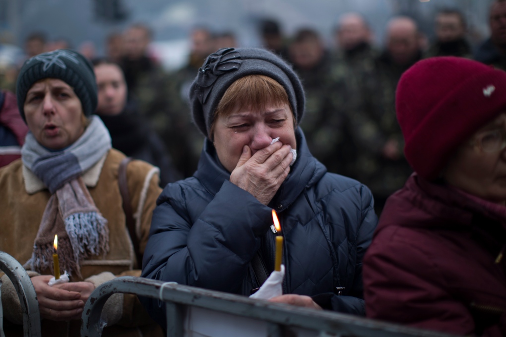 Ukraine woman weeps during funeral in Kyiv