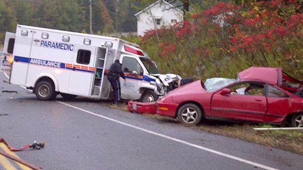 An ambulance and car lay on the side of Calabogie Road after a fatal crash on Saturday, Sept. 24, 2011.