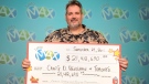 Toronto school teacher Craig Henshaw holds his cheque for a $21.4 million jackpot from the July 8, 2011 Lotto Max draw in Toronto, Tuesday, Sept. 27, 2011. (Ontario Lottery and Gaming Corporation- Nick Perry)