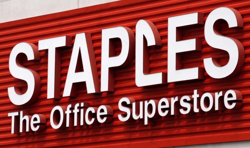 A Staples sign is displayed on the front of a Staples store, in Portland, Ore., in this May 17, 2011 file photo. (AP / Rick Bowmer)
