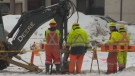 Crews work at a site on March 6, 2014 where a water main broke near Polo Park in Winnipeg earlier in the week.