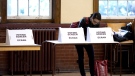 A woman casts her ballot at a voting station in Toronto as voters participate in the Ontario Provincial Election on Thursday October 6, 2011.(Chris Young / THE CANADIAN PRESS)