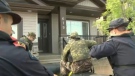Members of the High River RCMP searching homes following the flooding of the Highwood River
