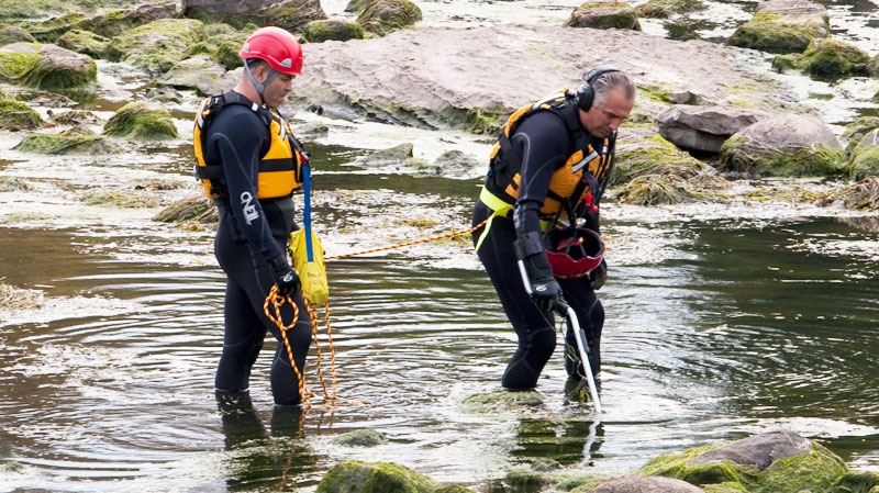 Police divers are scouring the Mile-Iles River near Terrebonne, Que., for new evidence in the 12-year-old missing persons case of Julie Surprenant Wednesday, Sept. 28, 2011. (Ryan Remiorz / THE CANADIAN PRESS)