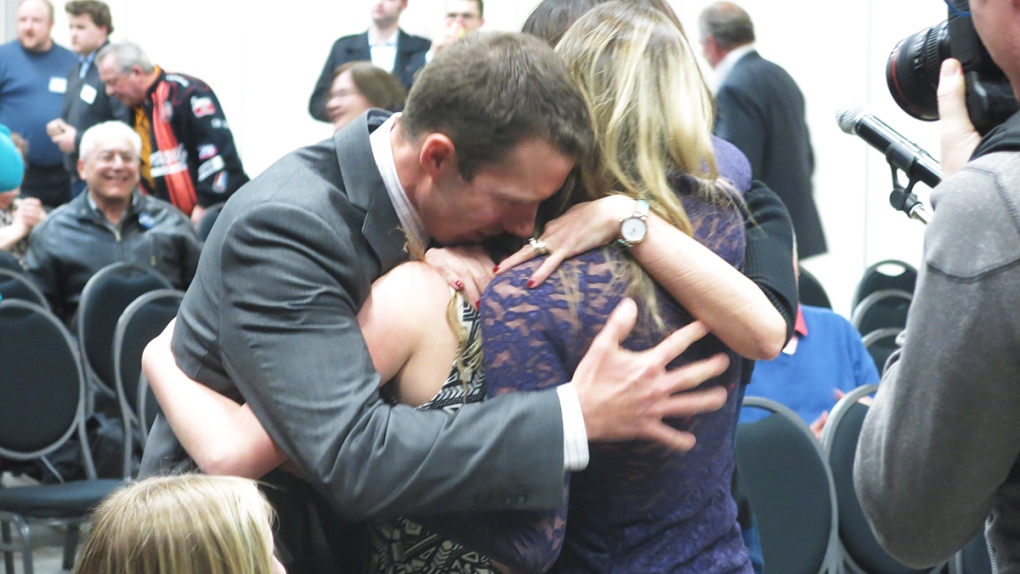 Conservative candidate John Barlow hugs his family