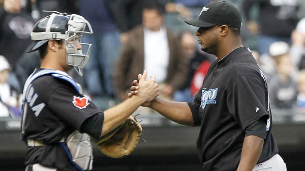 Toronto Blue Jays catcher J.P. Arencibia, left, celebrates with relief pitcher Frank Francisco after the Blue Jays' 3-2 win over the Chicago White Sox in a baseball game Wednesday, Sept. 28, 2011, in Chicago. (AP Photo/Charles Rex Arbogast)