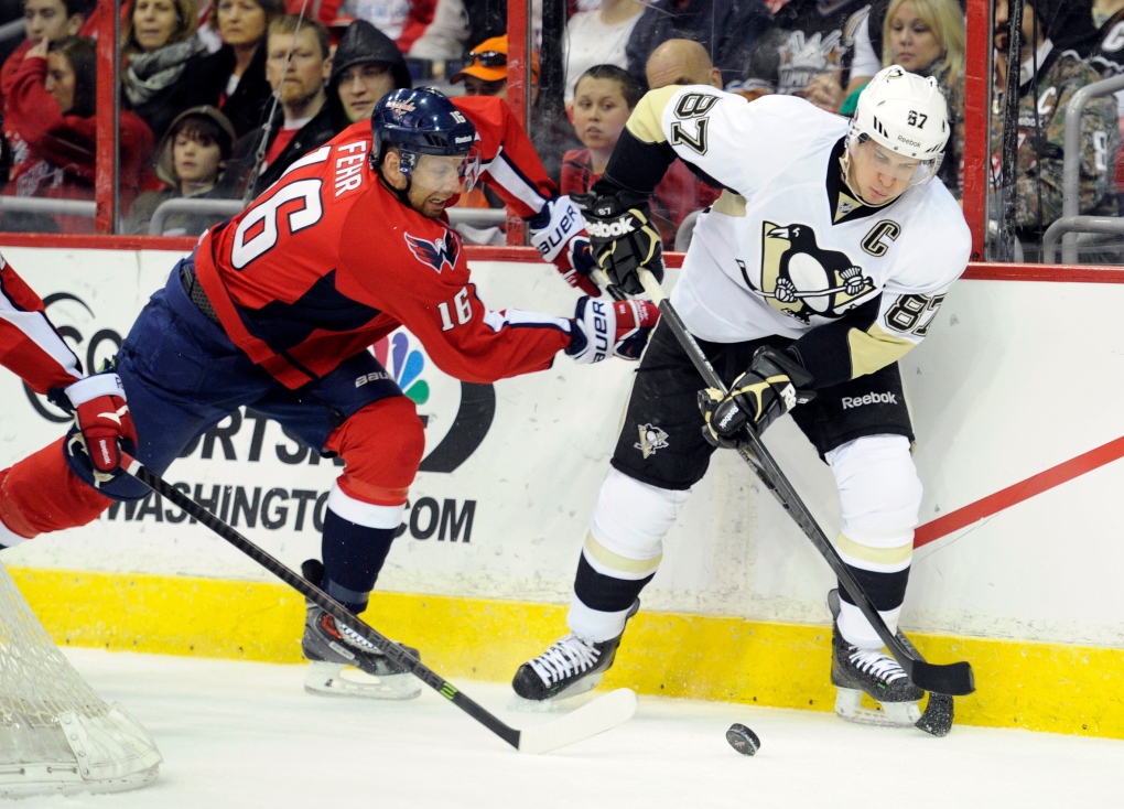 Eric Fehr fights for puck with Sidney Crosby