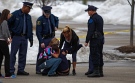 Skye Cieszlak, girlfriend of missing Saginaw Spirit hockey player Terry Trafford, is comforted after collapsing in the parking lot of the Saginaw Township Wal-Mart, Tuesday, March 11, 2014. (AP /The Saginaw News, Neil Barris)