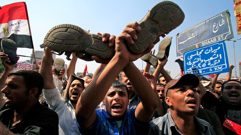 Egyptian demonstrator chant slogans as they attend a protest at Tahrir Square in Cairo, Egypt, Friday, Sept. 30, 2011. (AP / Khalil Hamra)