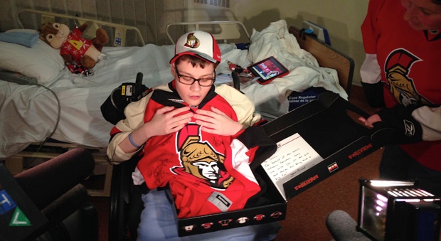 Justin Greer shows up his new team-signed Ottawa Senators Jersey. The 21-year-old lives with Spina Bifida and was recovering from hospital when an autographed picture of his favourite Sens was stolen from his mother's car. (Photo: Tyler Fleming/CTV Ottawa)