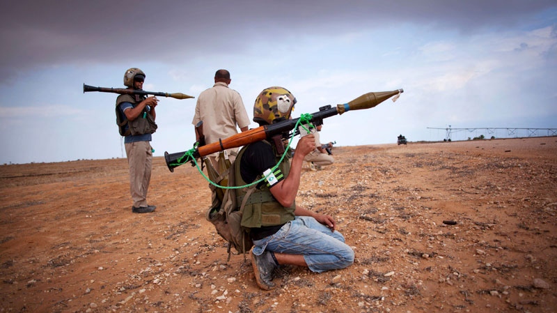 Revolutionary fighters armed with rocket-propelled grenades take up positions in Sirte, Libya, Saturday, Oct. 1, 2011. (AP / Manu Brabo)
