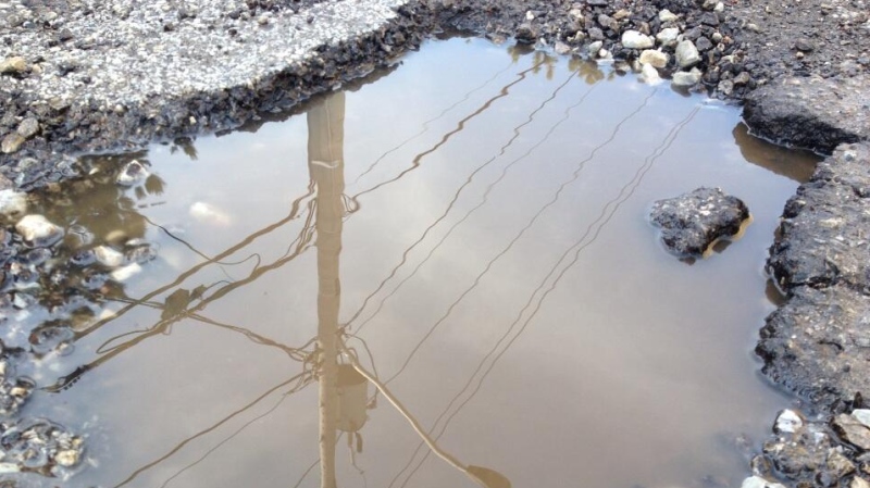 A pot hole can be seen on a Windsor road, Friday, March 14, 2014. (Rich Garton/ CTV Windsor)