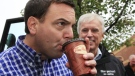Ontario Conservative Leader Tim Hudak has a drink of Tim Hortons coffee with Chatham-Kent-Essex candidate Rick Nicolls at a campaign stop in Blenheim, Ontario, Monday, Oct. 3, 2011. (Dave Chidley / THE CANADIAN PRESS)