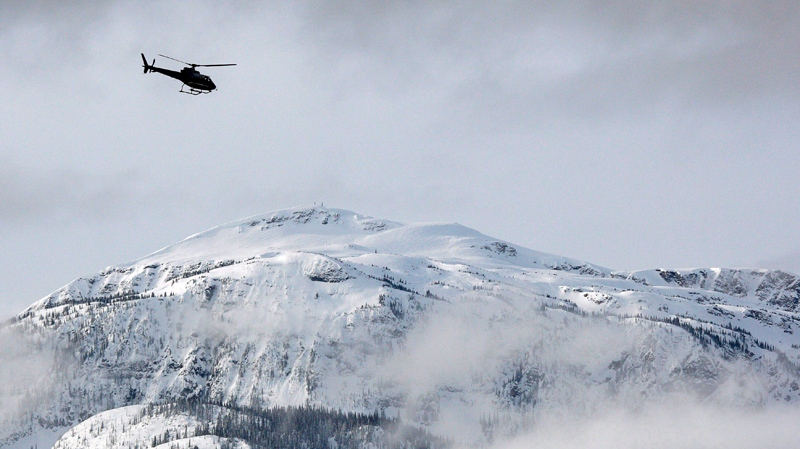 A search and rescue helicopter heads toward a dead