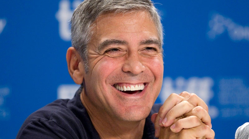 George Clooney laughs at a press conference for 'The Descendants' at the Toronto International Film Festival, Saturday, Sept. 10, 2011. (Chris Young / THE CANADIAN PRESS)  