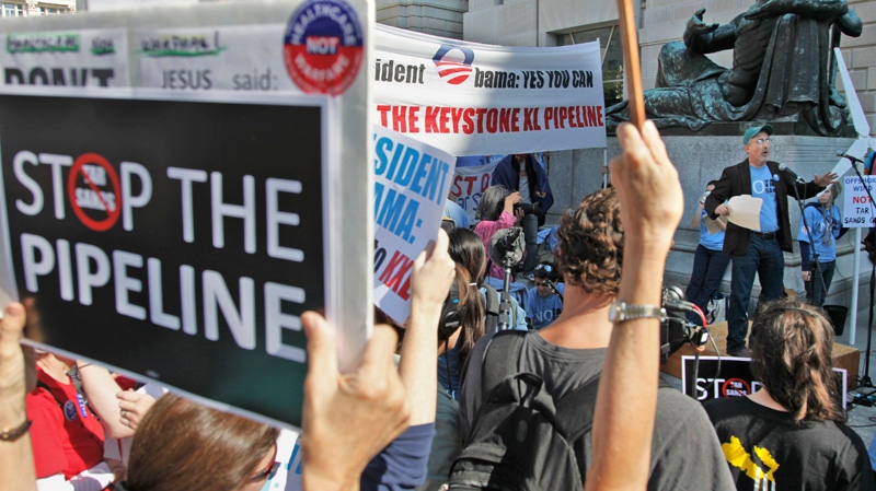 Mike Tidwell, from the Chesapeake Climate Action Network, right, addresses a rally  against the proposed Keystone XL pipeline outside the Ronald Reagan Building in Washington, Friday, Oct., 7, 2011. (AP / Pablo Martinez Monsivais)