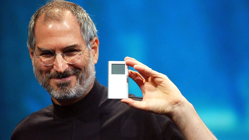 Apple CEO Steve Jobs displays the iPod mini at the Macworld Conference and Expo in San Francisco, Tuesday, Jan. 6, 2004. (AP / Marcio Jose Sanchez)