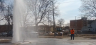 A EnWin employee can be seen standing near a watermain break in downtown Windsor in this YouTube video shot on Monday, March 24, 2014. (Michael Evans/ YouTube)