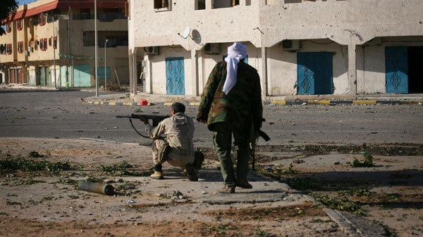 Revolutionary fighters fire their weapons against loyalist positions in the town of Sirte, Libya, Tuesday, Oct. 11, 2011. (AP / Manu Brabo) 