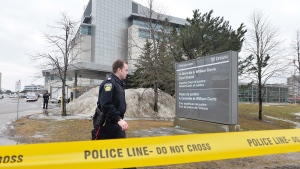 A Peel Region police officer is seen outside a Brampton, Ont., courthouse Friday, March 28, 2014. (Nathan Denette / THE CANADIAN PRESS)
