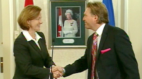 Premier Alison Redford and Education Minister Thomas Lukaszuk shake hands at the press conference where they announced that $107 million would be restored to school boards. Wednesday, October 12.