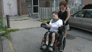 Jolanta Stansinska helps her son Jakub, 18, in his wheelchair (Oct. 13, 2011)