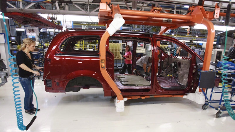 A Chrysler worker is seen on the assembly line at a plant in Windsor, Ont., on Jan. 18, 2011