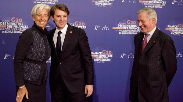 World Monetary Fund President, Christine Lagarde,, is welcomed by France's Finance Minister, Francois Baroin,, center, and Central Bank Governor, Christian Noyer, right, at the Cite de l'Architecture in Paris, Friday, Oct. 14, 2011. (AP / Fred Dufour, Pool)