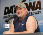 Comedian Larry the Cable Guy laughs during a news conference at Daytona International Speedway in Daytona Beach, Fla., on Feb. 22, 2014. (AP / David Graham)