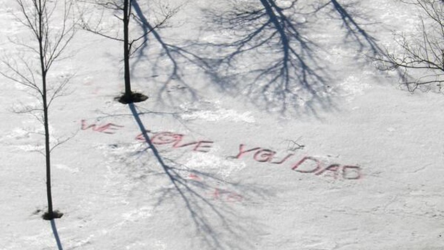 Daughters, 8 and 6, write message to ill father in the snow.