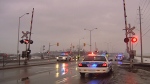 Police direct traffic at the VIA Rail crossing on Fallowfield Rd. after the signals malfunctioned on March 28, 2014. 


