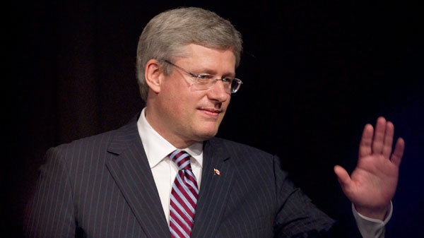 Prime Minister Stephen Harper acknowledges applause after delivering remarks to the Ukrainian Canadian Congress dinner in Toronto, Friday, Oct. 14, 2011. (Chris Young / THE CANADIAN PRESS)