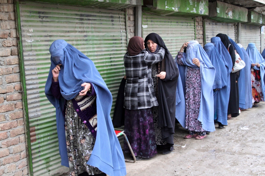Afghan women enter a polling station