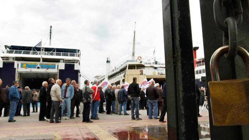 Port workers are seen during a strike in the port of Piraeus, near Athens, Monday, Oct. 17, 2011. (AP / Petros Giannakouris)