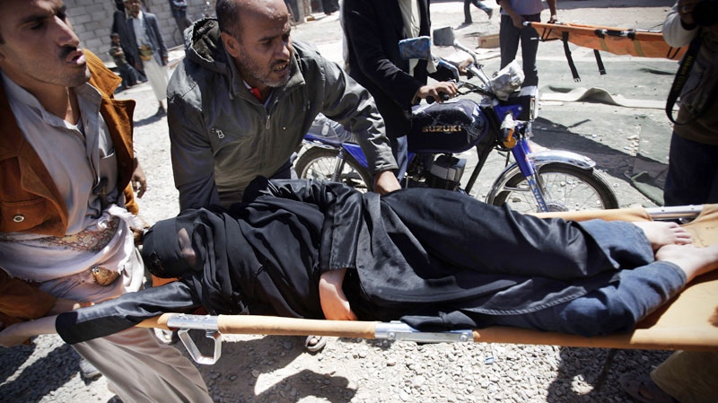Protestors carry a wounded woman from the site of clashes with security forces in Sanaa, Yemen, Tuesday, Oct. 18, 2011. (AP / Hani Mohammed)