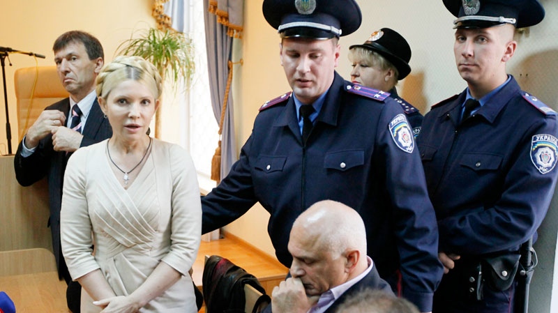 Police officers lead former Ukrainian Prime Minister Yulia Tymoshenko out of the courtroom after a verdict in her case has been rendered at the Pecherskiy District Court in Kiev, Ukraine, Tuesday, Oct. 11, 2011. (AP / Efrem Lukatsky)