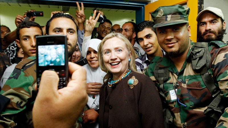 U.S. Secretary of State Hillary Rodham Clinton poses for a photo during a  visit to a Tripoli hospital during her visit to Libya, Tuesday Oct. 18, 2011. (AP / Kevin Lamarque, Pool)