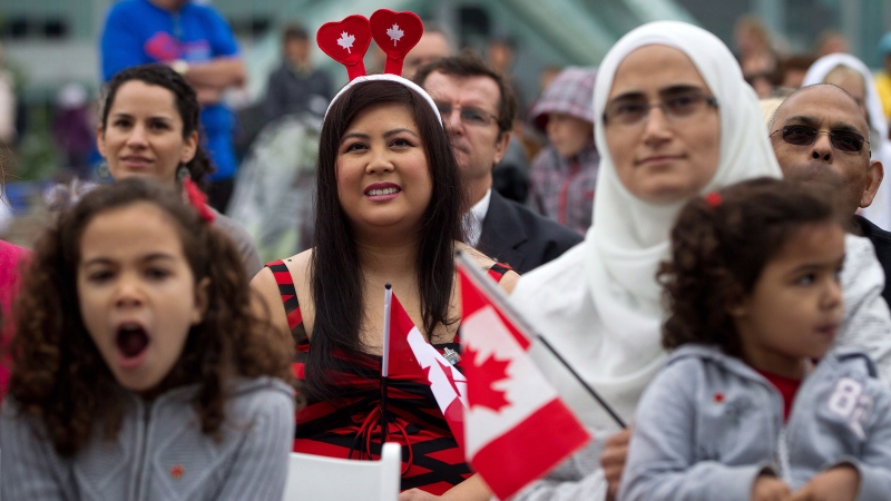 A group of immigrants look on before taking the oath of citizenship during a special Canada Day citizenship ceremony for 60 people in Vancouver, B.C., on Sunday July 1, 2012. (Daryl Dyck/The Canadian Press)
