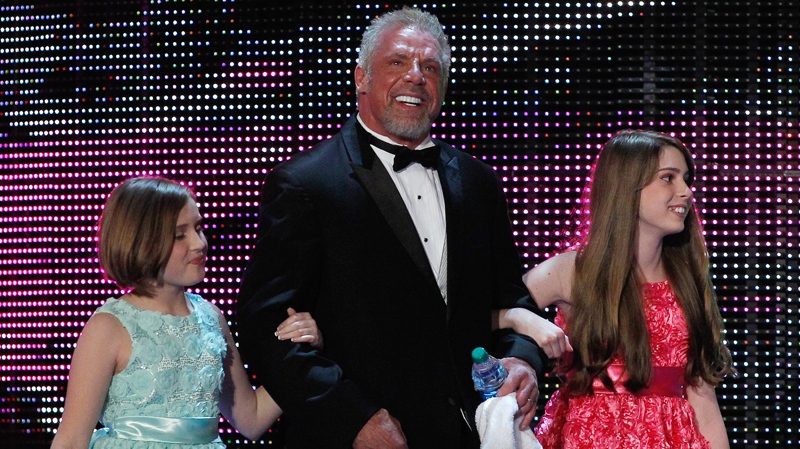 James Hellwig, aka The Ultimate Warrior, and his daughters at the WWE Hall of Fame Induction at the Smoothie King Center in New Orleans. (Jonathan Bachman/AP Images for WWE, File)