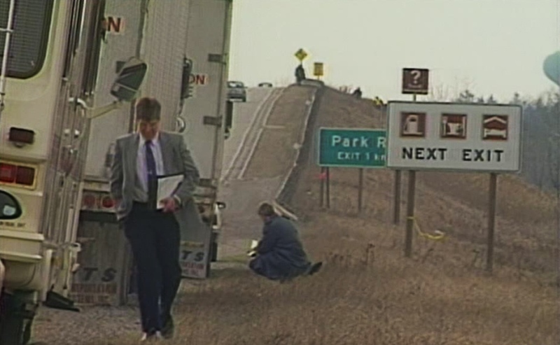 Police investigate the murder of Michael Lovejoy along Highway 403 in Brantford, Ont., in this image taken from video shot in 1994.