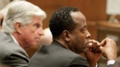 Dr. Conrad Murray, right, and his attorney J. Michael Flanagan look on during Murray's involuntary manslaughter trial, Wednesday, Oct. 19, 2011, in downtown Los Angeles.  (AP / Reed Saxon, Pool)