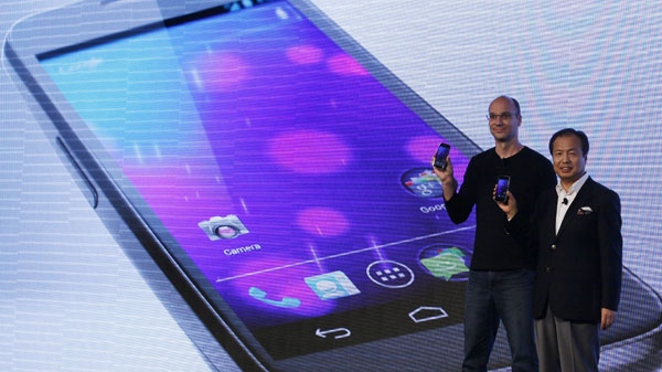 Google's top mobile executive Andy Rubin, left and J.K. Shin, president and head of mobile communications business from Samsung, hold the new Galaxy Nexus smartphone during the news conference in Hong Kong Wednesday, Oct. 19, 2011.