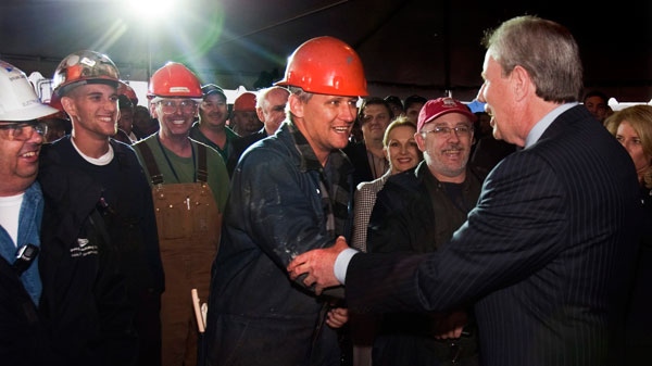 Jim Irving, right, CEO of Irving Shipbuilding, greets workers at the announcement that Halifax Shipyard is getting the $25 billion contract to build 21 Canadian combat ships, in Halifax on Wednesday, Oct. 19, 2011. (Andrew Vaughan / THE CANADIAN PRESS)
