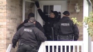 Police surround a Kitchener home on Copper Leaf Crescent on October 20, 2011.